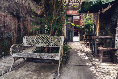 The streets of the old town of Takua pa, Phang Nga province, a cozy place in the shade, a shop in shabby walls, the interior of a coffee shop in a loft style photo