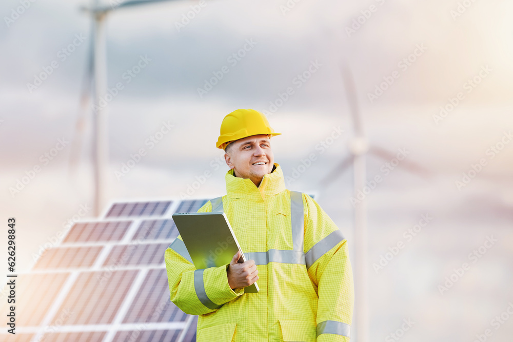 sustainable energy engineer. A technician after constructing and installing the solar panels and wind turbine farm. Renewable energy. sustainable energy engineer. A technician after constructing and installing the solar panels and wind turbine farm. Renewable energy.