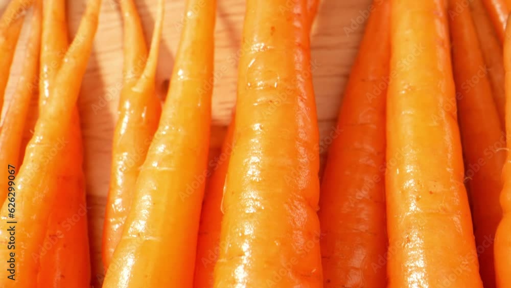 Mesmerizing macro video of baby carrots captured with a probe lens, showcasing their vibrant color, tender texture, and irresistible freshness. Food and vegetable concept. Baby carrots background
Mesmerizing macro video of baby carrots captured with a probe lens, showcasing their vibrant color, tender texture, and irresistible freshness. Food and vegetable concept. Baby carrots background