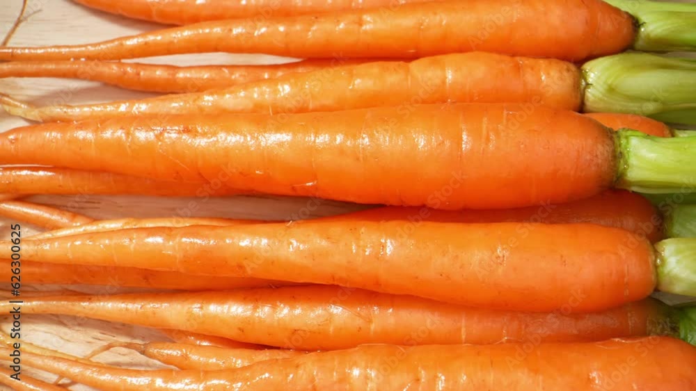 Macro video of baby carrots shot with a probe lens reveals their vibrant orange hue, delicate ridges, and luscious texture. Vegetable concept. Baby carrots background. 4K HDR
Macro video of baby carrots shot with a probe lens reveals their vibrant orange hue, delicate ridges, and luscious texture. Vegetable concept. Baby carrots background. 4K HDR