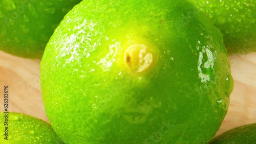 Green lemons, also known as unripe lemons, are harvested before full maturity. They are bright green and have a firmer texture compared to yellow lemons. Citrus and fruit concept
 photo