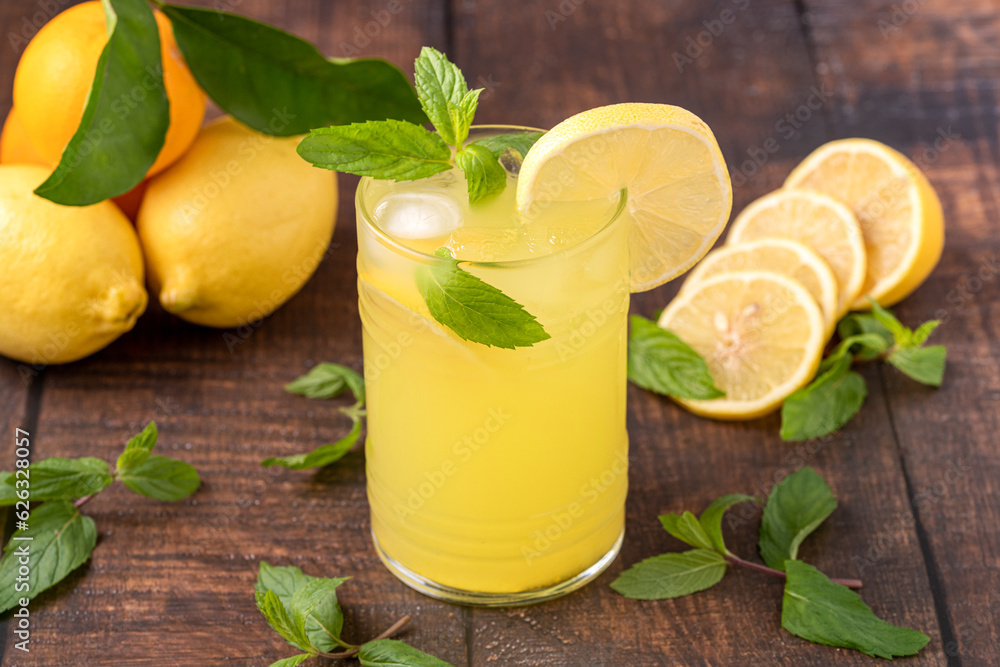 Iced lemonade in glass glass on wooden table Iced lemonade in glass glass on wooden table