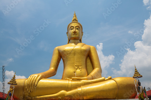 Big gold Buddha with blue sky in Wat Bang Chak near Ko Kret