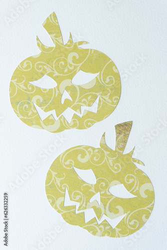 two sophisticated scrapbook paper halloween jack-o-lantern cutouts on textured paper photo