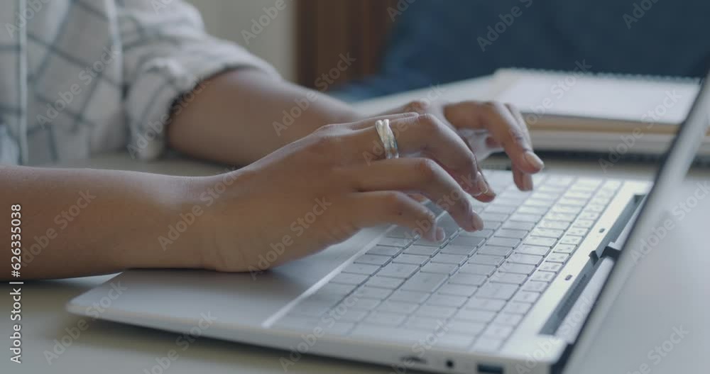 Close-up of female IT specialist typing with laptop programming creating software at desk indoors. People and modern technology concept. Close-up of female IT specialist typing with laptop programming creating software at desk indoors. People and modern technology concept.