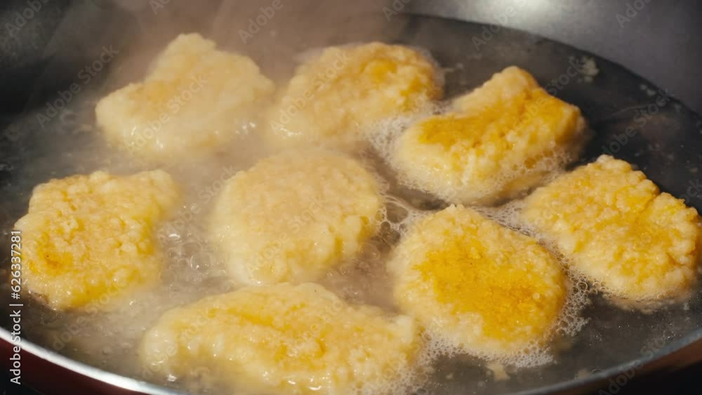Deep Fried chicken nuggets with olive oil in frying pan, close up of cooking junk food. Deep Fried chicken nuggets with olive oil in frying pan, close up of cooking junk food.