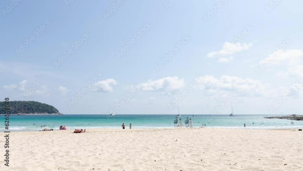 timelaspe 4k video of crowded people relaxing sunbath during Summer Vacation At tropical Beach in naiharn beach,Phuket.People in vacations on beach during summer daytime timelaspe 4k video of crowded people relaxing sunbath during Summer Vacation At tropical Beach in naiharn beach,Phuket.People in vacations on beach during summer daytime
