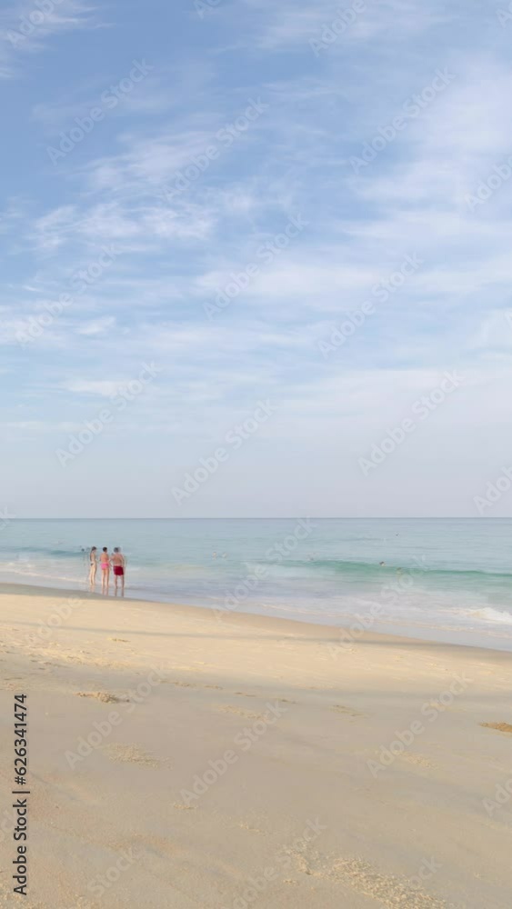 veritcal timelapse tropical white sand smooth beach with calm sea ocean and sunrise clear blue sky background with crowded people relaxing on the tropical white sand beach veritcal timelapse tropical white sand smooth beach with calm sea ocean and sunrise clear blue sky background with crowded people relaxing on the tropical white sand beach