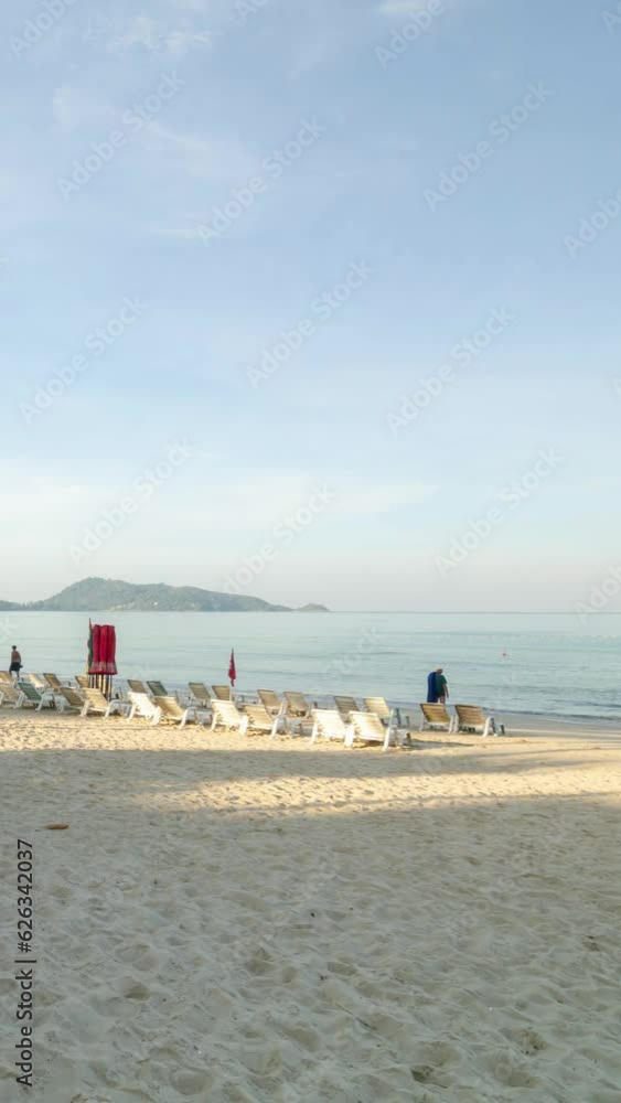 veritcal timelapse tropical white sand smooth beach with calm sea ocean and sunrise clear blue sky background with crowded people relaxing on the tropical white sand beach veritcal timelapse tropical white sand smooth beach with calm sea ocean and sunrise clear blue sky background with crowded people relaxing on the tropical white sand beach