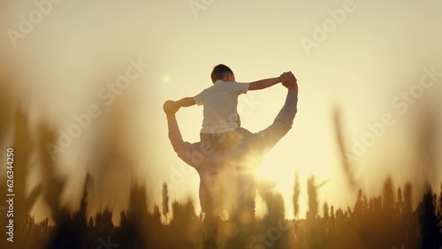 man father play with his son child airplane. family game airplane pilot. dream childhood dad. little kid child boy with his father plays airplane pilot sunset wheat field. little son walks field with photo