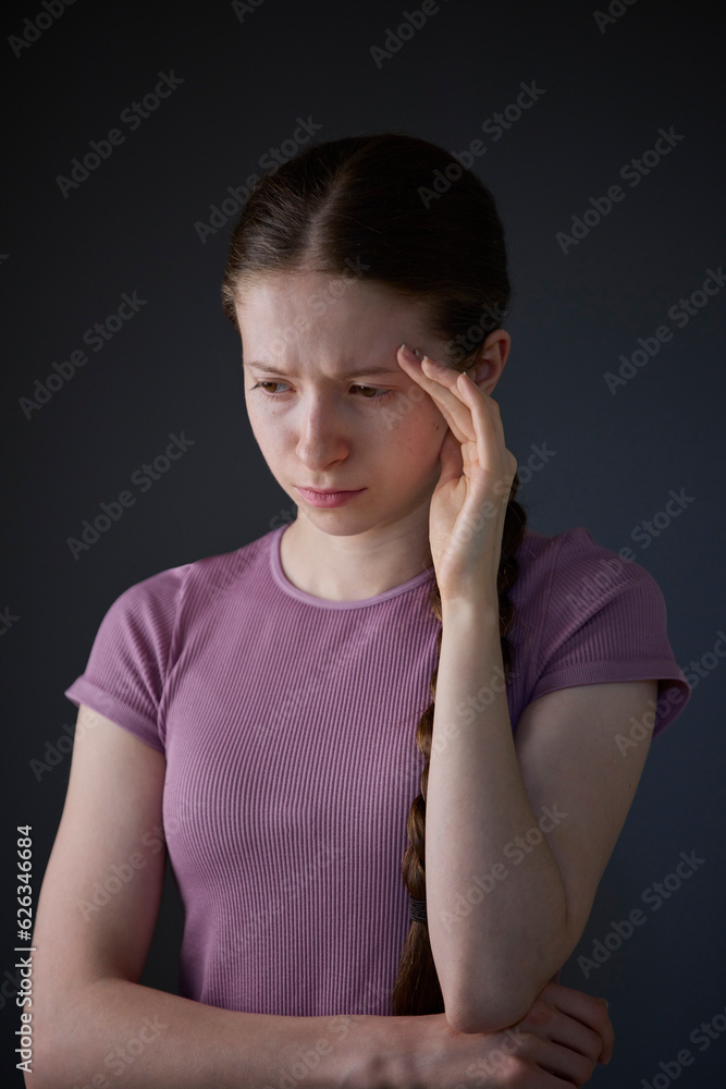 Low Key Studio Portrait Of Stressed Teenage Girl Worried About Mental Health Issues Or Bullying Low Key Studio Portrait Of Stressed Teenage Girl Worried About Mental Health Issues Or Bullying