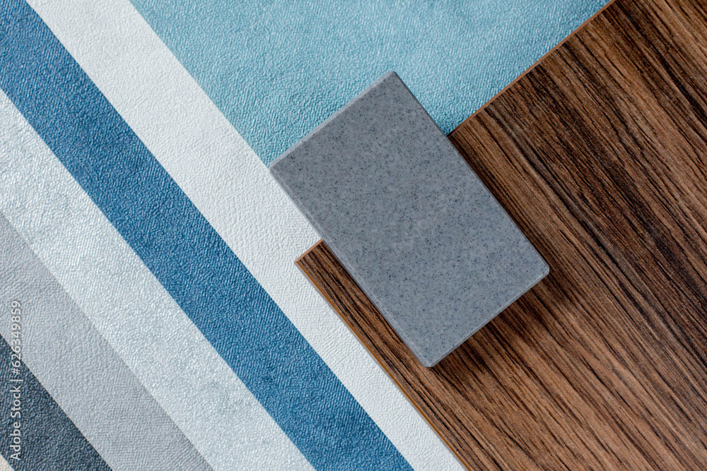 Fototapeta premium samples of finishing materials, close-up view, including various wooden laminates, interior wallpaper, gray artificial stone