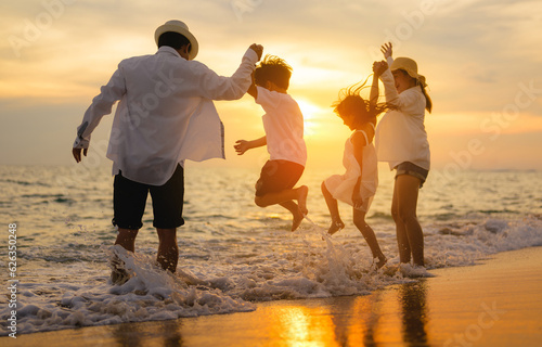 Tableau sur toile Happy family enjoying together on beach on holiday vacation, Family with beach t