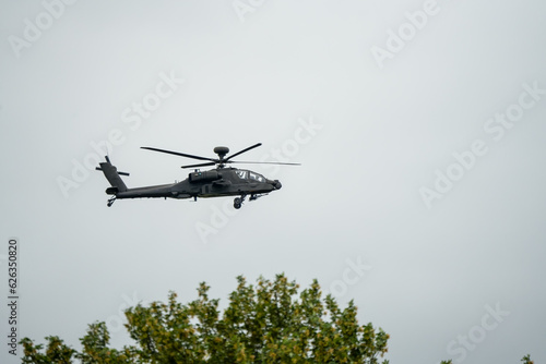 close-up of British army AH-64E Boeing Apache Attack helicopter in low level flight, Wiltshire UK