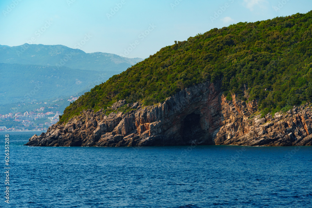 Fototapeta premium seascapes, a view of the rocks and a sea cave on the Bay of Kotor during a cruise on a ship in Montenegro, a bright sunny day, the concept of a summer trip