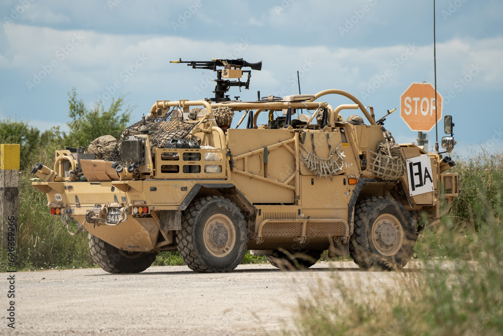 Close-up of a British army Supacat Jackal at a road crossing, Wiltshire UK Close-up of a British army Supacat Jackal at a road crossing, Wiltshire UK