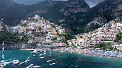Positano resort, Italy, famous old italian resort and Tyrrenian sea, Background Beach Water House Summer Nature Italy Landscape, Beautiful flight over Amalfi, Colorful dark clouds in sunrise sunset  photo
