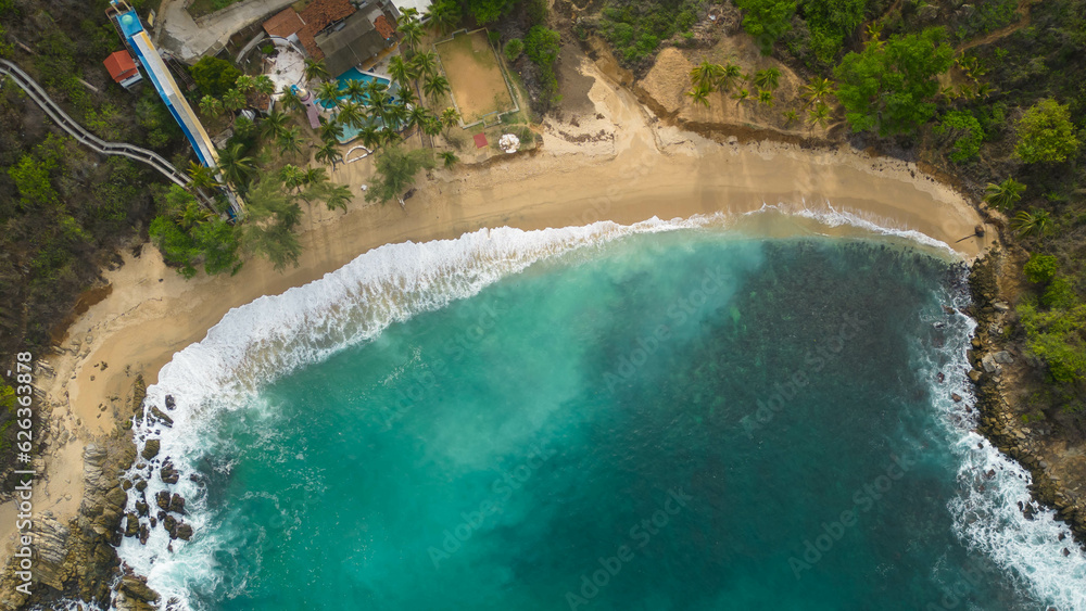 Above coral beach, turquoise waters and white sands from a bird's eye view. Puerto Escondido, Oaxaca, Mexico
