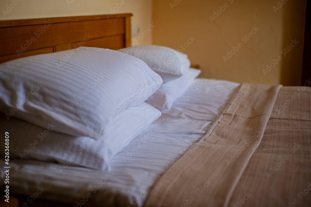 pillows on the bed in the hotel room, cozy atmosphere rest pillows on the bed in the hotel room, cozy atmosphere rest