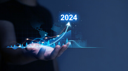 Businessman holding growth graph a year 2024 of business and data analysis. Development to success in year 2024.