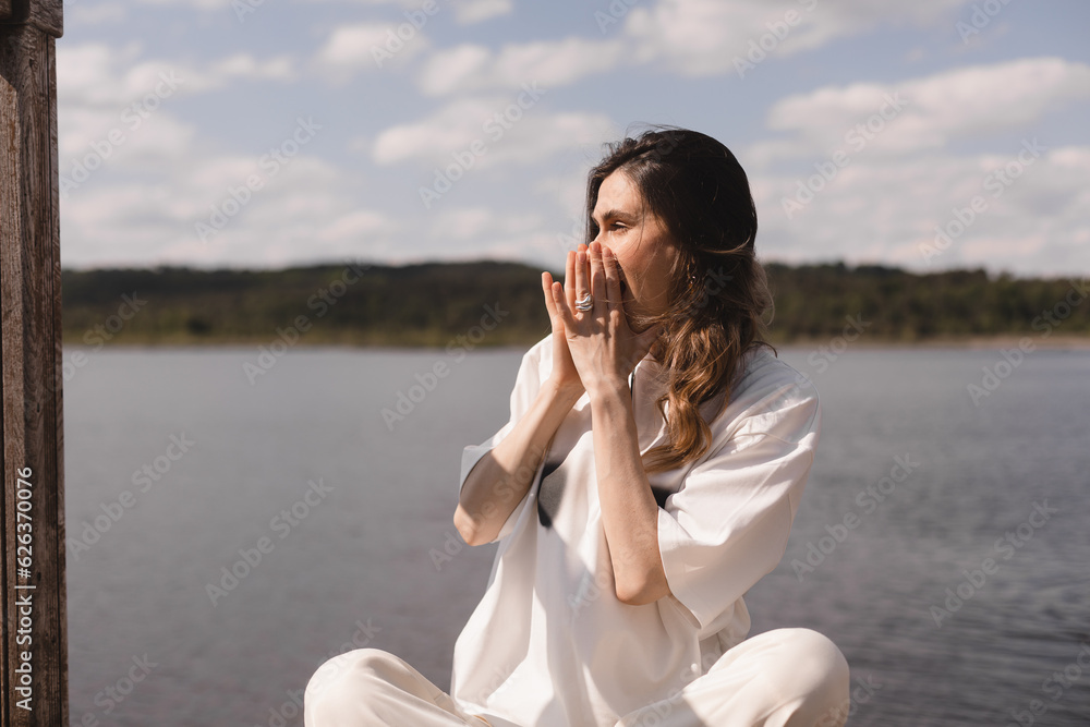 Happy woman hold hands near mouth and shout of freedom, scream call her friends. Woman look happy and  joyful. Emotional recovery, traveler girl rest in the lake.