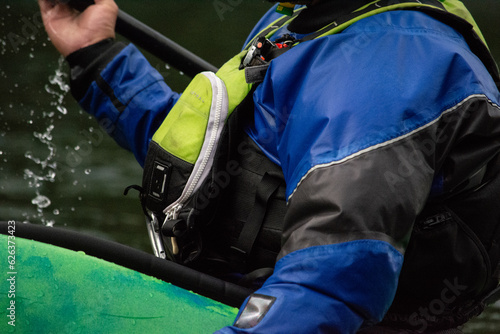 close up of kayaker on the water and the gear they are wearing