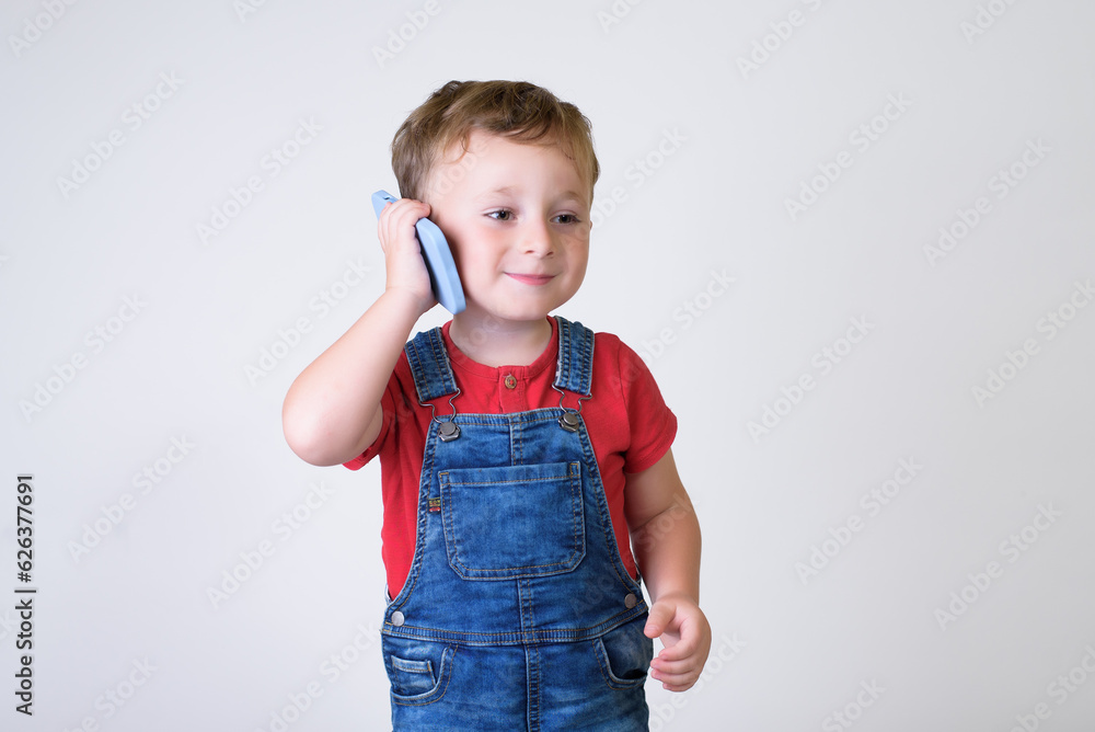 Smiling boy using cell phone isolated in white studio Smiling boy using cell phone isolated in white studio