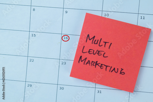 Concept of Multi Level Marketing write on sticky notes isolated on Wooden Table.