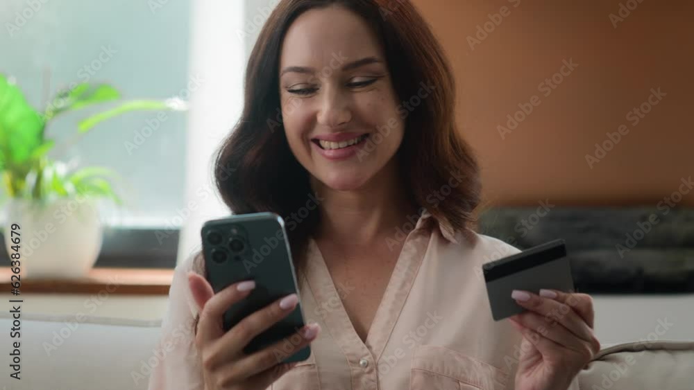 Happy smiling client customer female buyer user Caucasian lady girl shopping with mobile phone bank app pay online buy goods order ecommerce from home woman make internet transaction with credit card Happy smiling client customer female buyer user Caucasian lady girl shopping with mobile phone bank app pay online buy goods order ecommerce from home woman make internet transaction with credit card