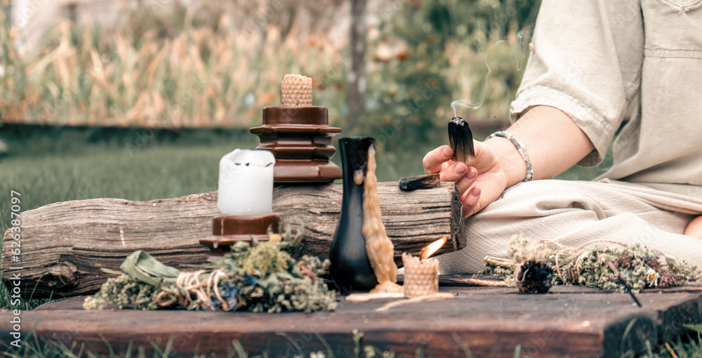Woman Inhaling Incense Smoke During Meditation.Ground level of relaxed