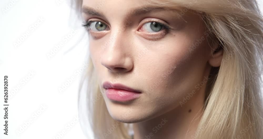 Powerful close up portrait of a melancholic woman. Against a pristine white background, her expressive eyes speak volumes as she gazes directly into the camera, conveying a profound sense of sadness. Powerful close up portrait of a melancholic woman. Against a pristine white background, her expressive eyes speak volumes as she gazes directly into the camera, conveying a profound sense of sadness.
