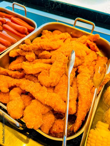 Fried chicken - Crispy hot chicken tenders in serving tray at buffet. in street food. at catering event on some festive event,party or wedding. Buffet