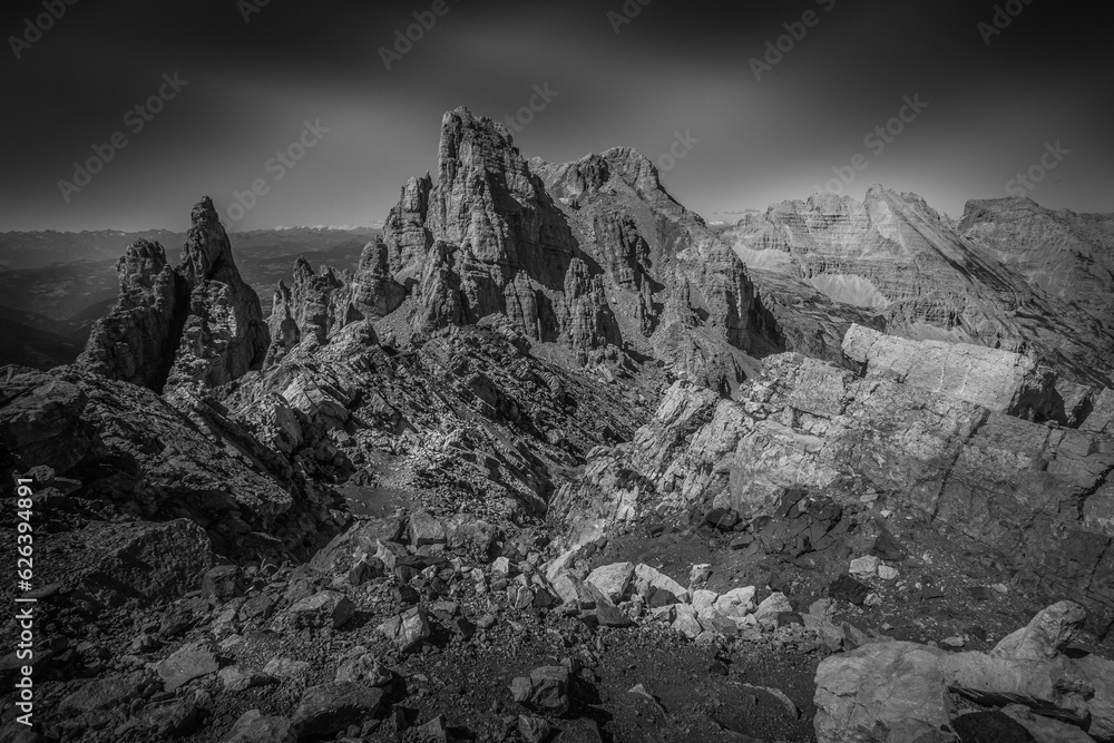Black and white dolomite rocky scene with giant pinnacles and ridges in the Latemar Massif, UNESCO world heritage site. The main pinnacle is named Torre di Pisa. Trentino-Alto Adige, Italy, Europe