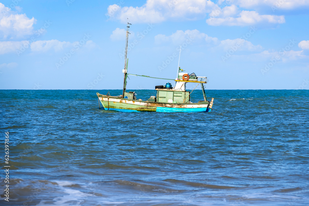 Fototapeta premium Fisherman's boat at sea. Old fishing boat
