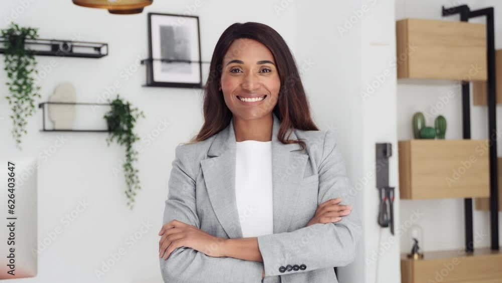 Confident smiling young professional business woman ceo corporate leader, female African American lawyer or real estate agent, hr manager wearing suit standing arms crossed in office, portrait. Confident smiling young professional business woman ceo corporate leader, female African American lawyer or real estate agent, hr manager wearing suit standing arms crossed in office, portrait.
