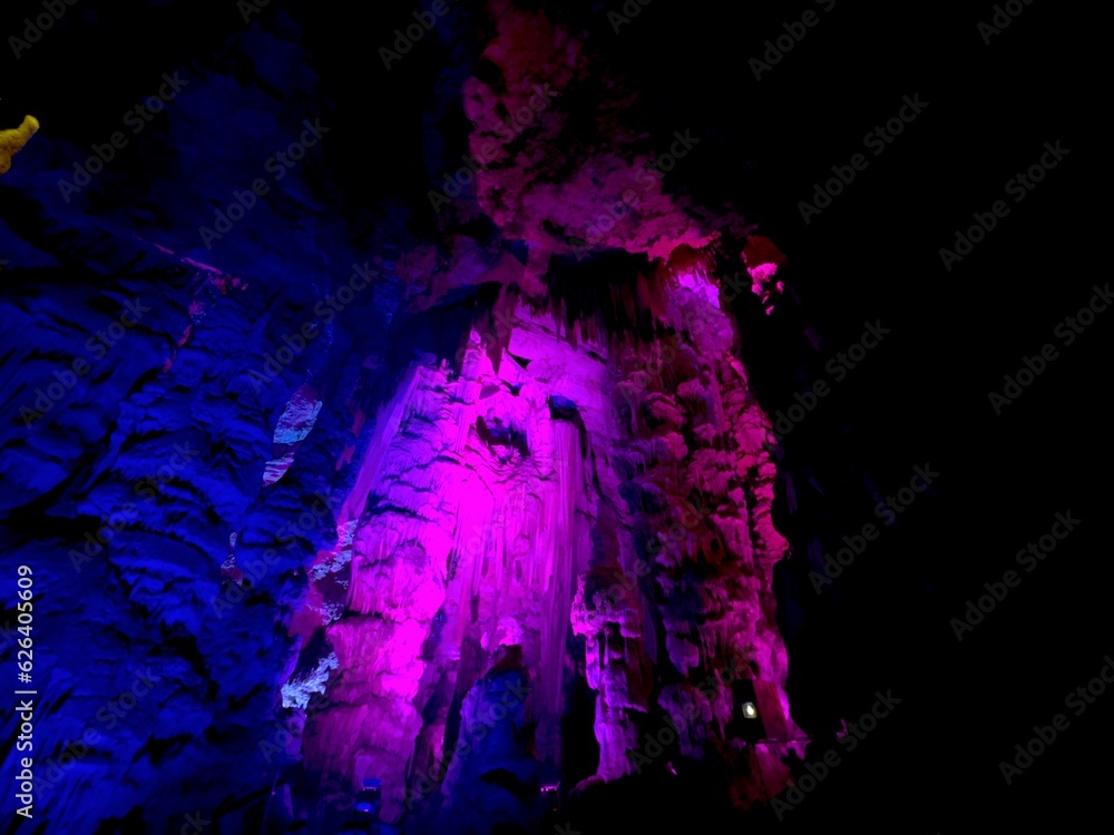 Fototapeta premium famous artistically colorfully illuminated St. Michael's Cave in the Rock of Gibraltar, British Overseas Territory, Great Britain, Europe