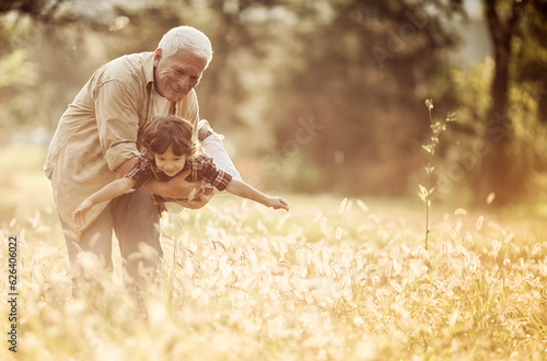 Young boy and his grandfather spending time at the park forest photo