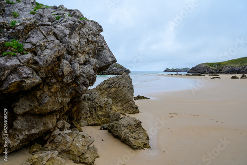 View on Playa de Borizo in Celorio, Green coast of Asturias, North Spain with sandy beaches, cliffs, hidden caves, green fields and mountains. photo
