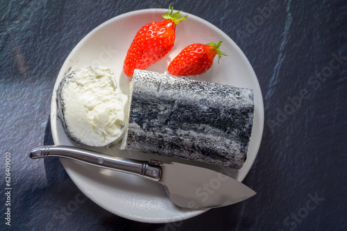 French fresh goat cheese bouche with black mold served with fresh red strawberry, France photo