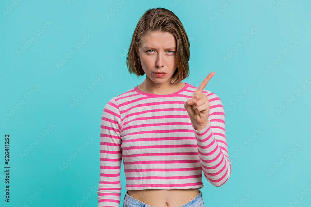 Displeased upset Caucasian woman reacting to unpleasant awful idea, dissatisfied with bad quality, wave hand, shake head No, dismiss idea, dont like proposal. Girl isolated on blue studio background Displeased upset Caucasian woman reacting to unpleasant awful idea, dissatisfied with bad quality, wave hand, shake head No, dismiss idea, dont like proposal. Girl isolated on blue studio background
