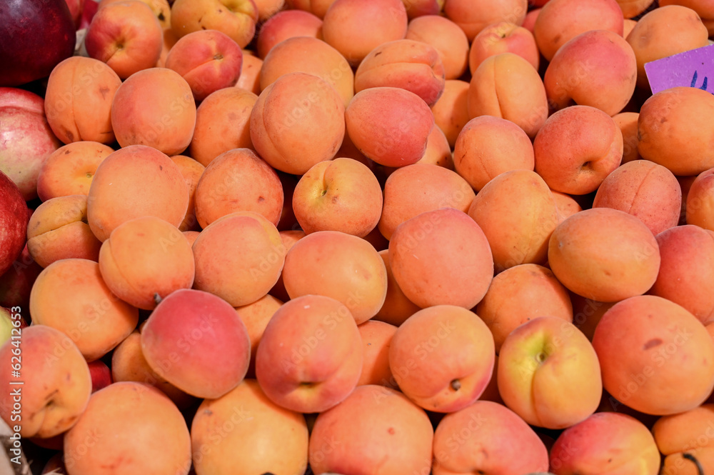 Apricot for sale at fruit market, close up. Boxes full of raw apricots in supermarket. Apricot for sale at fruit market, close up. Boxes full of raw apricots in supermarket.