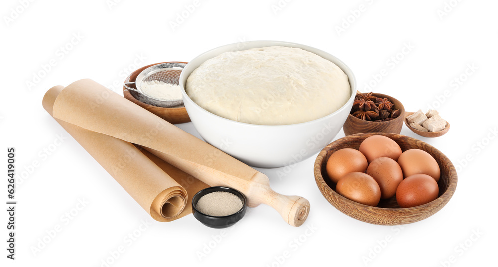 Composition with fresh yeast dough, parchment paper and ingredients on white background. Making cake Composition with fresh yeast dough, parchment paper and ingredients on white background. Making cake