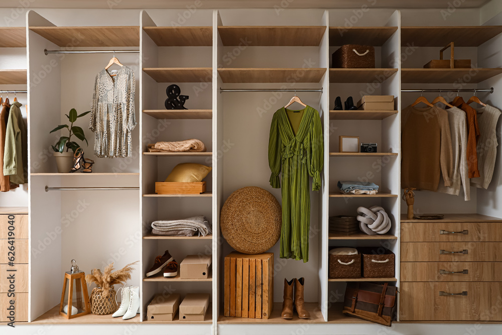 Fototapeta premium Stylish clothes with modern shoes and accessories in boutique