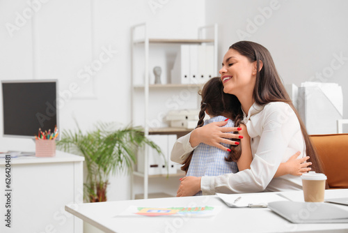 Working mother with her lit...