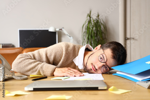 Exhausted young man with gl...