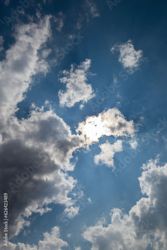 Fototapeta Naklejka Na Ścianę i Meble -  sky replacement vertical blue sky with clouds and sun shining through
