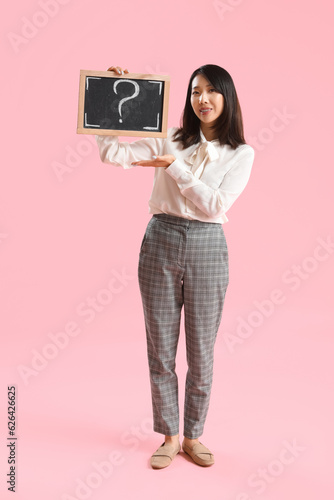 Female Asian teacher holdin...