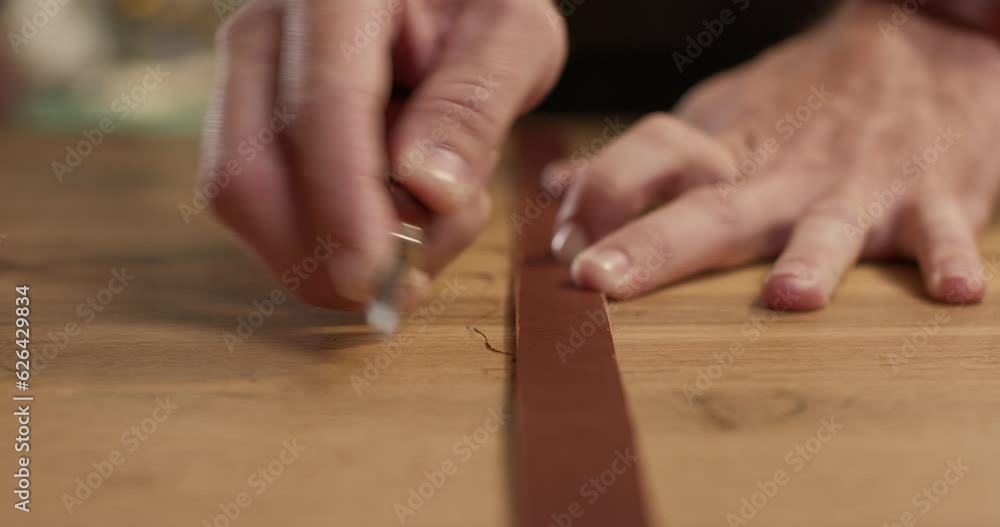 craftsman working with Leather Edge Beveler at workshop, blurred background Slow motion. young handsome guy polish the edge of belt Man sewing leather belt at workplace. Masterclass, workshop session craftsman working with Leather Edge Beveler at workshop, blurred background Slow motion. young handsome guy polish the edge of belt Man sewing leather belt at workplace. Masterclass, workshop session