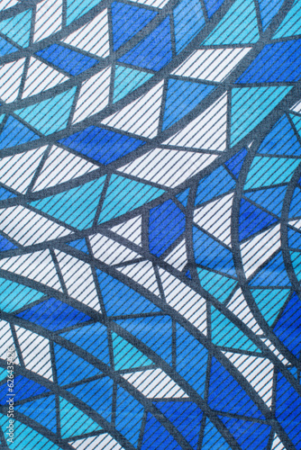 top view of blue and white ankara fabric, selective focus of nigerian wax cloth, rumpled blue and white ankara material