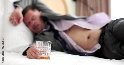 A drunken businessman sleeps alone in clothes, a close-up, slowmotion. Stressful situation, problem at work